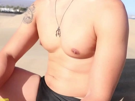 Asian hunk gets his nipples teased in the sand