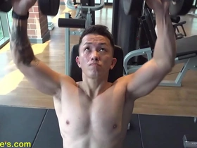 A handsome Asian man getting fit in the gym before a nipple play session.