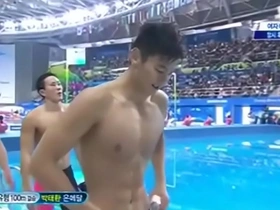 Asian hunk shows off his abs and swims in the ocean.