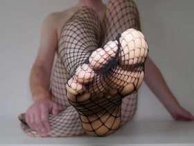 Feet in fishnet pantyhose tights